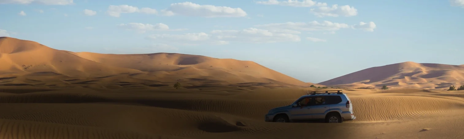 A car moving in a desert.