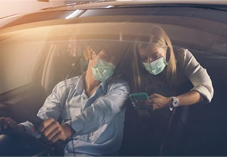 Couple using a smartphone to book an eco-friendly ride with Uprides.